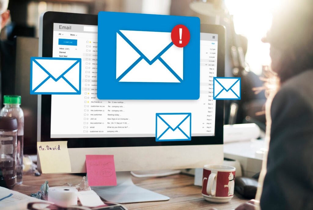 Business owner crafting an email newsletter on a laptop